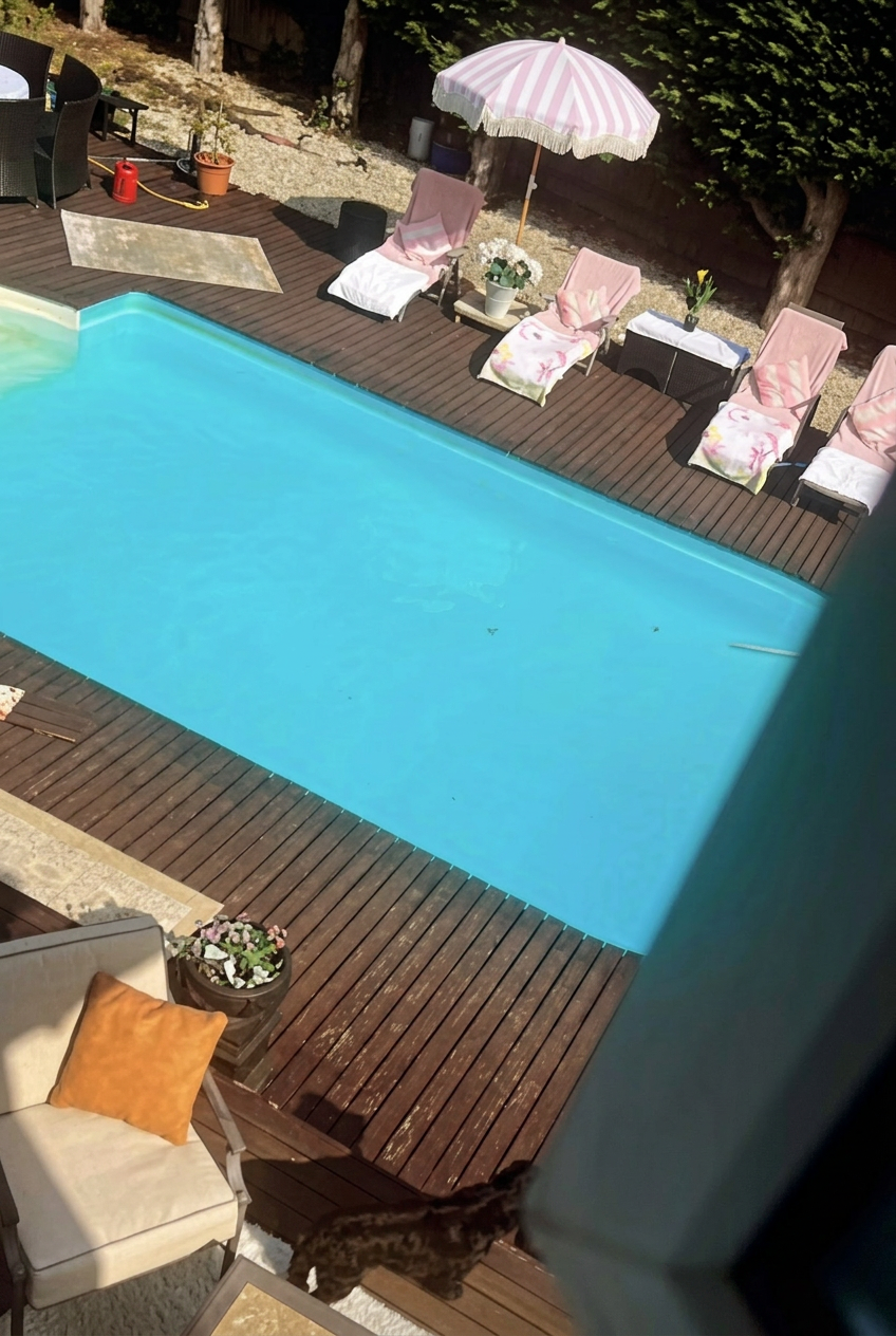 Poolside sun loungers with striped umbrella at Forest View